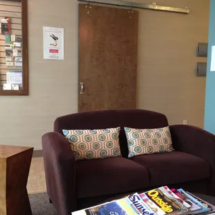 Reception area comfy couch with plenty of magazines