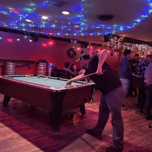 people playing pool in a bar