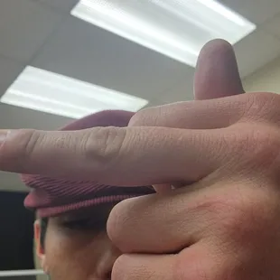 a man holding his finger up to the camera