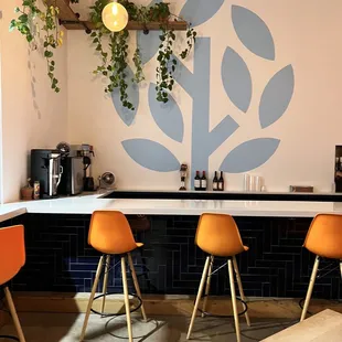 a bar with orange chairs