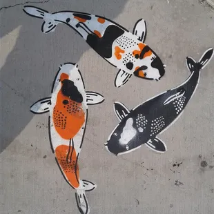 Koi fish chalked on the sidewalk in front of the Jamba Juice in the 1st St. shopping plaza