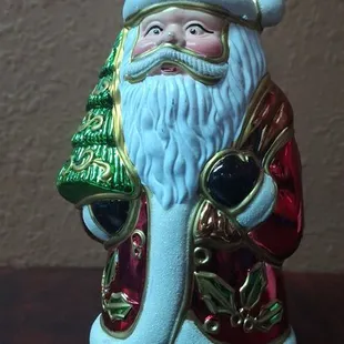 santa holding a christmas tree