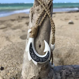 This carved bone hook necklace is believed to "hook" you good luck! www.livingalohacreations.com