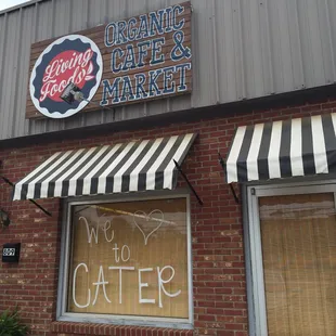 a storefront with a sign that says organic cafe market