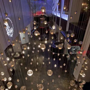 a chandelier of glass balls suspended from the ceiling