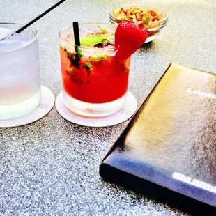 a drink and a book on a table