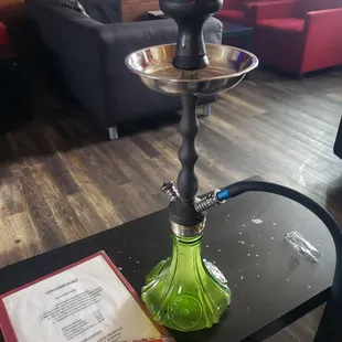 a table with a green glass vase on it