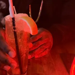 a person sitting at a table with a drink