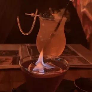 a man sitting at a table with a drink
