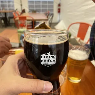 a person holding a glass of beer