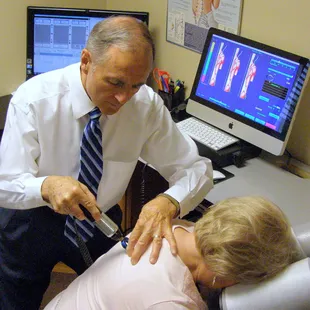 Dr Wilcox adjusting a patient with the computerized adjusting instrument.