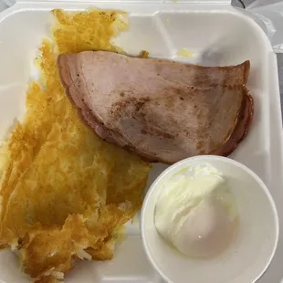 a ham and eggs in a styrofoam container