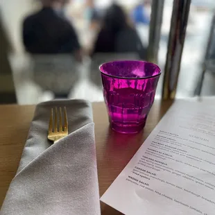 a glass of wine and a napkin on a table