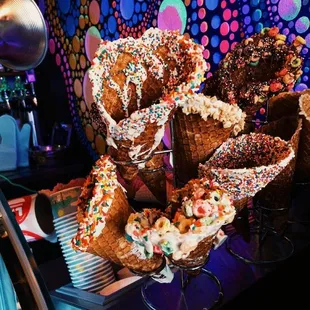 a display of ice cream cones with sprinkles and sprinkles