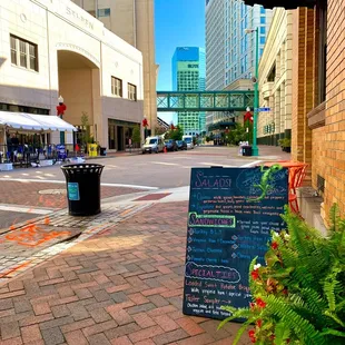 a sign on a brick sidewalk
