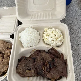 a tray of meat, rice, and beans
