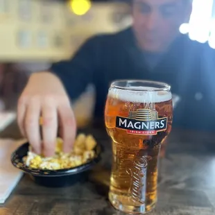 a glass of beer and a plate of food