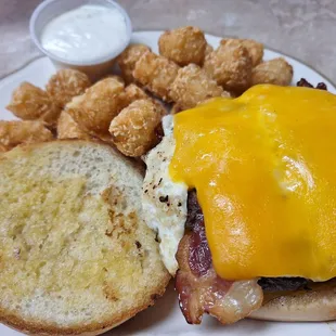 Upgraded double breakfast burger with cheddar cheese and tater tots. Delicious but an expensive combo at $16 w drink.