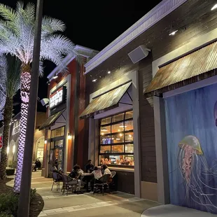 people eating outside at night