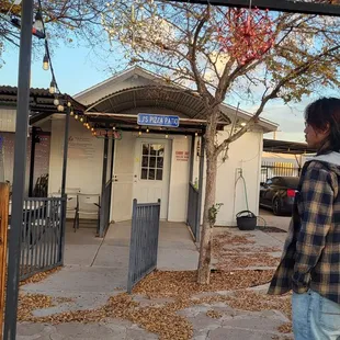 a man standing in front of a restaurant
