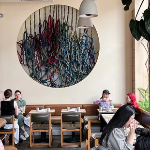 people sitting at tables in a restaurant