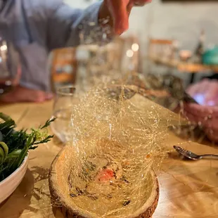 a man sprinkling a bowl of food