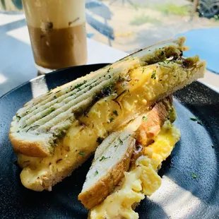 Llama Sunrise Breakfast Panini -- smoked paprika aioli sauce, fluffy eggs, bacon jam, creamy guacamole, mozzarella cheese
