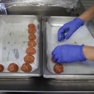two trays of meatballs
