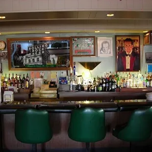 the bar with green chairs