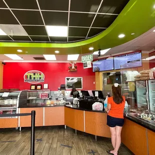 a woman standing in front of a counter