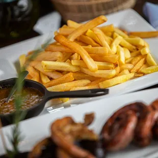 a plate of french fries and hot dogs