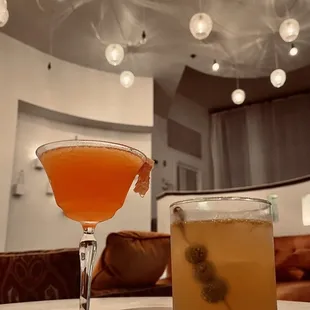 a cocktail and a drink on a table