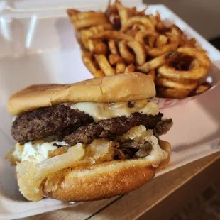 Mushroom Swiss burger with curly fries.