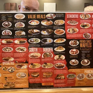 a man holding up a menu