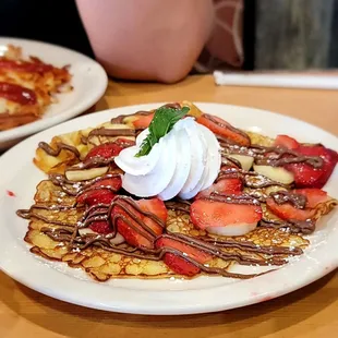 Nutella, strawberry  banana  crepes with whip and a mint leaf for looks!