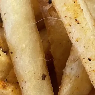 Loaded fries with small white animal looking hair.