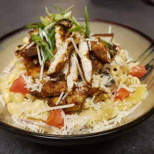 a bowl of pasta with meat and vegetables