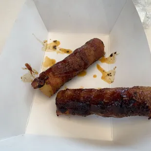 two sausages in a paper container