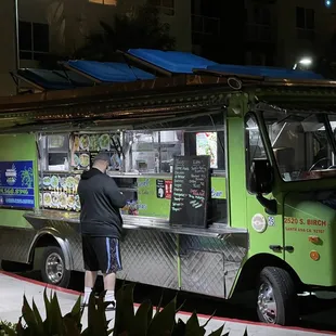 a man standing in front of a food truck