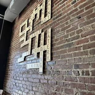 a brick wall with scrabbles on it