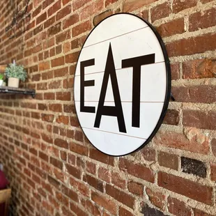 a sign on a brick wall