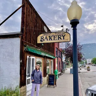 a woman standing in front of a store