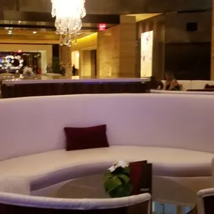 a curved seating area in a hotel lobby
