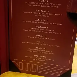 a menu and a glass of wine