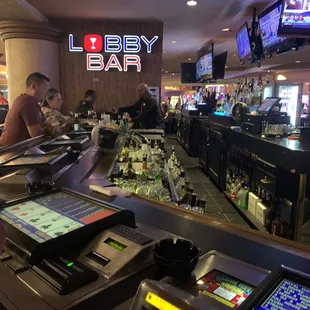 people at the bar and televisions in the background