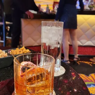 a glass of whiskey and a donut