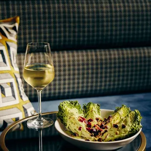 a bowl of salad and a glass of wine