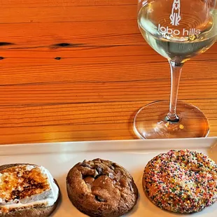 three donuts and a glass of wine