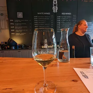 a woman sitting at a bar with a glass of wine