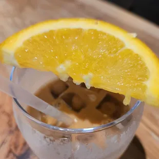 an orange slice in a glass